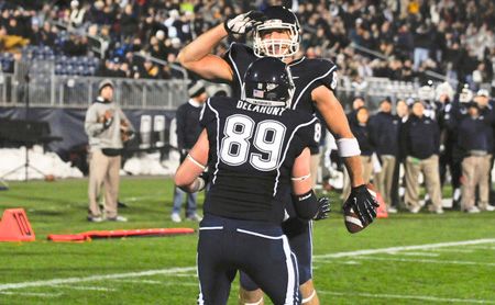  Ryan Griffin celebrates his first-half touchdown reception against Pitt with teammate John Delahunt at Rentschler Field in East Hartford. 