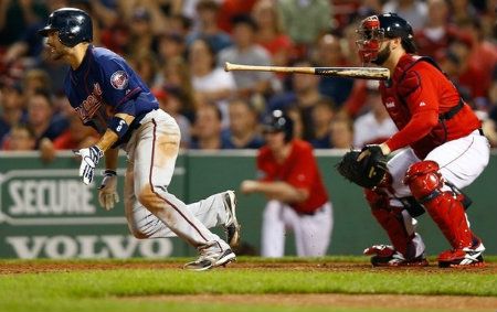 Jamey Carroll #8 of the Minnesota Twins hits an RBI single in the 10th inning against the Boston Red Sox during the game on August 3, 2012 at Fenway Park in Boston, Massachusetts.