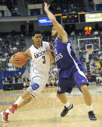 UConn's Jeremy Lamb drives to the basket against Holy Cross guard R.J. Evans at the XL Center Sunday afternoon. Evans played at Norwich Free Academy.