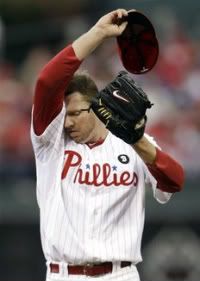 Philadelphia Phillies starting pitcher Roy Halladay (34) wipes his face during the first inning in Game 1 of baseball's National League division series against the St. Louis Cardinals Saturday, Oct. 1, 2011 in Philadelphia.