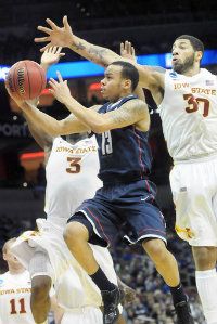 UConn's Shabazz Napier shoots under pressure from Iowa State forward Melvin Ejim, left, and forward Royce White as the Huskies struggle in the first half at the KFC Yum! Center in Louisville, Ky. 