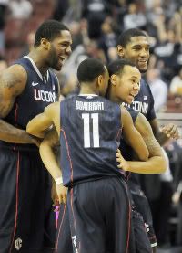 UConn's Shabazz Napier gets a hug from Ryan Boatright and cheers from Alex Oriakhi and Roscoe Smith after sinking the winning three-pointer with 0.6 seconds left on the clock. 