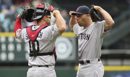 Closing pitcher Alfredo Aceves #91 of the Boston Red Sox celebrates with catcher Kelly Shoppach #10 after defeating the Seattle Mariners 2-1 in ten innings at Safeco Field on July 1, 2012 in Seattle, Washington.