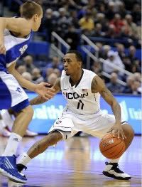 Connecticut's Ryan Boatright dribbles past Seton Hall's Haralds Karlis during the second half of his team's 69-46 victory in an NCAA college basketball game in Hartford, Conn., on Saturday, Feb. 4, 2012.