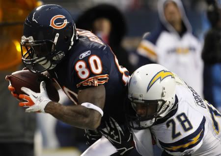 Chicago Bears wide receiver Earl Bennett makes a catch as San Diego Chargers' Steven Gregory (R) tackles him in the first half of their NFL football game in Chicago, Illinois, November 20, 2011. The Bears won the game 31-20.