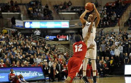  Shabazz Napier, who made 3 of 5 three-pointers and scored a game-high 19 points, is fouled by Stony Brook's Marcus Rouse late in UConn's 73-62 win.