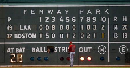 Vernon Wells #10 of the Los Angeles Angels of Anaheim stands in left field in front of the scoreboard in the 10th inning during the game on August 23, 2012 at Fenway Park in Boston, Massachusetts.