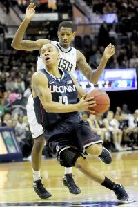 UConn's Shabazz Napier drives past Notre Dame guard Eric Atkins in the first half.