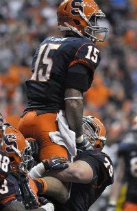 Syracuse receiver Alec Lemon celebrates in the arms of Zack Chibane after scoring against Connecticut during the third quarter of an NCAA college football game in Syracuse, N.Y., Friday, Oct. 19, 2012.