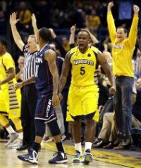 Marquette's Junior Cadougan (5) reacts to his 3-pointer that tied the score at the end of regulation against Connecticut in their NCAA college basketball game, Tuesday, Jan. 1, 2013, in Milwaukee. 