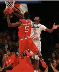  DeAndre Daniels #2 of the Connecticut Huskies tries to block a shot from C.J. Leslie #5 of the North Carolina State Wolfpack during the Jimmy V Classic on December 4, 2012 at Madison Square Garden in New York City.