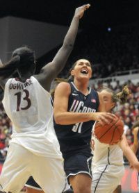  UConn's Stefanie Dolson drives to the basket against Stanford's Chiney Ogwumike at Roscoe Maples Pavilion Saturday afternoon. 