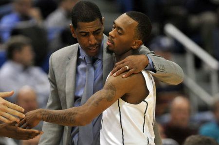 UConn coach Kevin Ollie talks with Ryan Boatright as he comes off the court late in UConn's 61-53 win over New Hampshire.