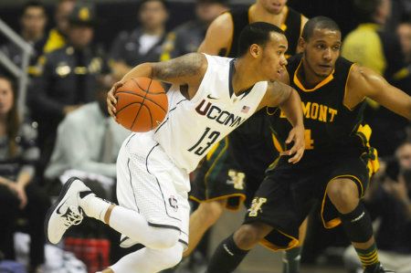 University of Connecticut Huskies guard Shabazz Napier drives past Vermont Catamounts guard Trey Blue