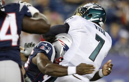New England Patriots linebacker Jermaine Cunningham (L) sacks Philadelphia Eagles quarterback Michael Vick during the first quarter of their preseason NFL football game in Foxborough, Massachusetts August 20, 2012. Vick was hurt on the play and taken out of the game against the Patriots.