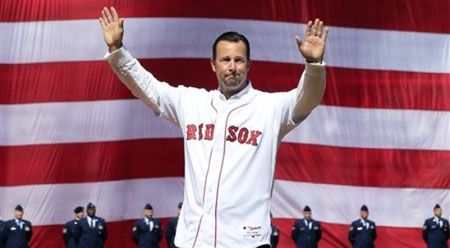 Former Boston Red Sox pitcher Tim Wakefield acknowledges the crowd before throwing a ceremonial first pitch at the home opener of the Boston Red Sox against the Tampa Bay Rays in a baseball game at Fenway Park in Boston, Friday, April 13, 2012.