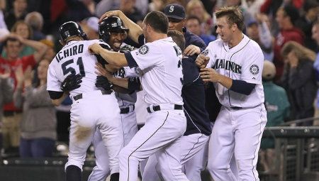 Chone Figgins #9 of the Seattle Mariners is mobbed by teammates after hitting the game winning sacrifice fly in the eleventh inning to defeat the Boston Red Sox 3-2 at Safeco Field on June 30, 2012 in Seattle, Washington.