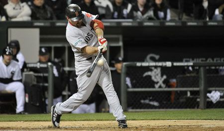 Kevin Youkilis #20 of the Boston Red Sox connects on a grand slam scoring teammates David Ortiz #34, Adrian Gonzalez #28 and Ryan Sweeney #12 during the third inning against the Chicago White Sox at U.S. Cellular Field on April 26, 2012 in Chicago, Illinois. 