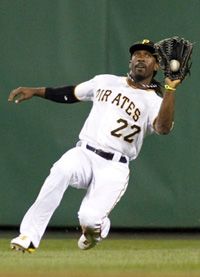 Andrew McCutchen #22 of the Pittsburgh Pirates makes a sliding catch against the St. Louis Cardinals during the game on August 29, 2012 at PNC Park in Pittsburgh, Pennsylvania.