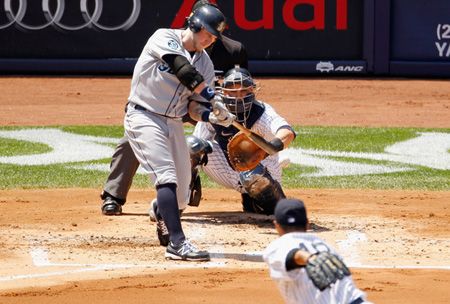 Mike Carp #20 of the Seattle Mariners hits an RBI single in the second-inning against the New York Yankees at Yankee Stadium on August 4, 2012 in the Bronx borough of New York City.