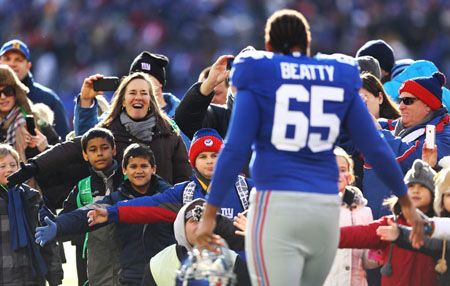  Will Beatty #65 of the New York Giants greets families of Sandy Hook Elementary School before the game against the Philadelphia Eagles their game against the at MetLife Stadium on December 30, 2012 in East Rutherford, New Jersey. 