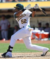 Yoenis Cespedes #52 of the Oakland Athletics hits a ground ball with the bases loaded scoring Cliff Pennington #2 of the Oakland Athletics (not pictured) in the bottom of the fourth inning giving the Oakland Athletics a 6-0 lead over the Boston Red Sox at O.co Coliseum on September 2, 2012 in Oakland, California. 