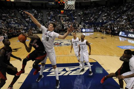 Louisville Cardinals guard Russ Smith drives against UConn forward Tyler Olander Monday night at the XL Center.