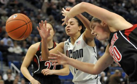  UConn's Bria Hartley fights for an offensive rebound with Jude Schimmel, left, and Sara Hammond of Louisville. 