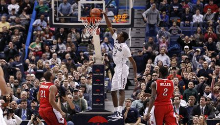  UConn forward DeAndre Daniels dunks between Rutgers forward Austin Johnson (21) and guard/forward Dane Miller. 