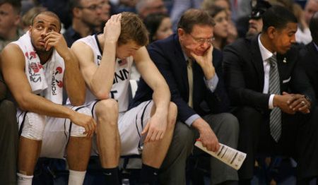 UConn players R.J. Evans, and Neils Giffey with coaches George Blaney and Kevin Ollie absorb UConn's loss to Villanova 61-70 at the XL Center in Hartford Saturday. 