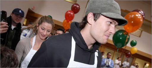 Brady (r), Bundchen (center) and I think that's Red Sox pitcher Jon Lester in the background with the Goodwill hat on.  Globe Photo.  