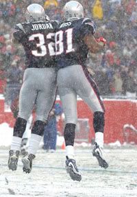 Patriots running back LaMont Jordan (32) celebrates his touchdown with wide receiver Randy Moss (81) during New England's game against the Arizona Cardinals at Gillette Stadium - Patriots.com Photo