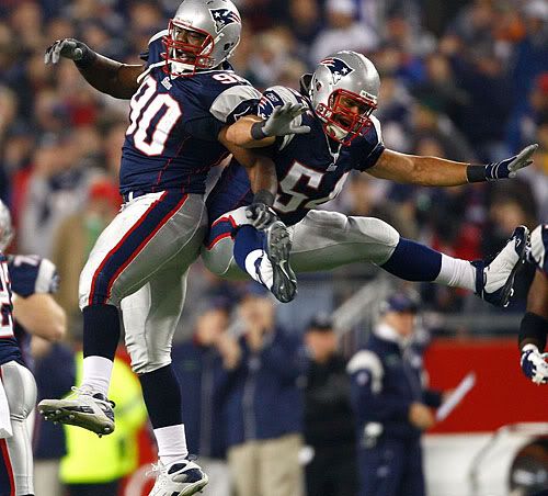 Smith and Bruschi celebrate a fumble recovery.  Getty Photo.  
