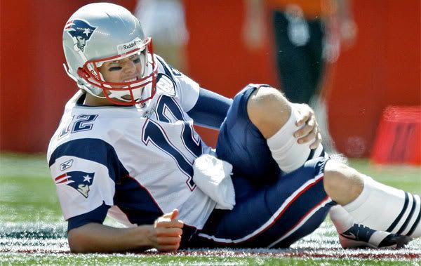 Brady went down in the first quarter and hearts of Patriots fans everywhere dropped with him.  Globe photo.
