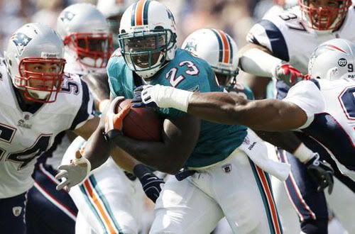 Ronnie Brown busts through the Patriots defense for a TD in the second quarter.  AP Photo.