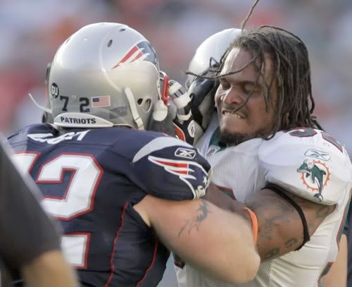 Miami Dolphins linebacker Channing Crowder, right, and New England Patriots tackle Matt Light fight during the fourth quarter of an NFL football game in Miami. Both were ejected from the game and the Patriots defeated the Dolphins 48-28. ALAN DIAZ / AP Photo.
