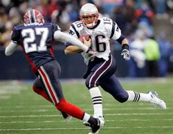 New England Patriots quarterback Matt Cassel runs under pressure from Buffalo Bills' Reggie Corner (27) during the first half of an NFL football game at Ralph Wilson Stadium - AP Photo