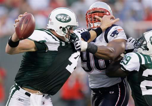 Adalius Thomas starts to wrap up Jets QB Brett Favre and RB Leon Washington with a big fourth quarter sack in the Pats 19-10 win.  AP Photo