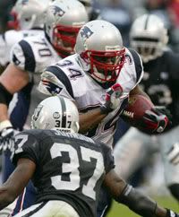 New England Patriots Sammy Morris runs past Oakland Raiders Chris Johnson (37) for a touchdown in the first half of an NFL football game - AP Photo