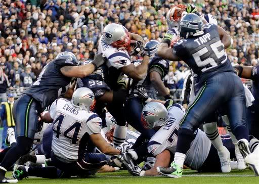 New England Patriots running back Sammy Morris goes over the top of Seattle Seahawks' defensive tackle Rocky Bernard (99) to score a touchdown in the fourth quarter of an NFL football game, Sunday, Dec. 7, 2008, at Qwest Field in Seattle - AP Photo
