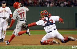 Jason Varitek tags out Reggie Willits on a failed suicide squeeze bunt.