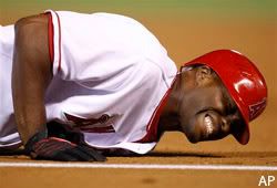 Torii Hunter lays in pain after hurting his knee while arguing a close call at first base.