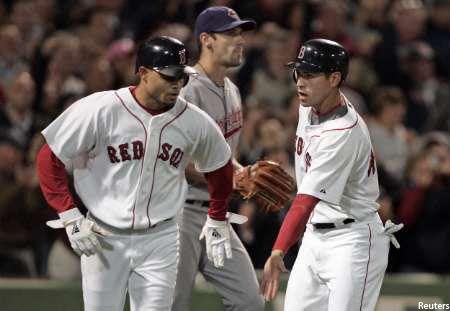 Coco Crisp and Jacoby Ellsbury congratulate each other as Cliff Lee looks on.