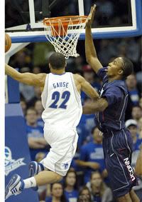 Thabeet goes for a block on Paul Gause - Courant Photo