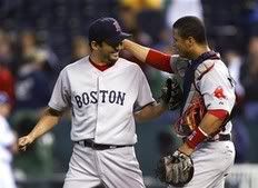 Boston Red Sox relief pitcher Takashi Saito, left, and Victor Martinez celebrate a 10-3 win over the Kansas City Royals during in a baseball game Thursday, Sept. 24, 2009, in Kansas City, Mo - AP Photo