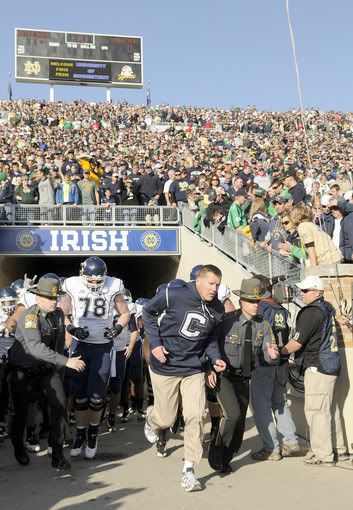 UConn head coach Randy Edsall leads his team onto the field at Notre Dame Saturday afternoon for what would be the program's biggest victory to date, a 33-30 overtime victory over the Fighting Irish - John Woike/Hartford Courant