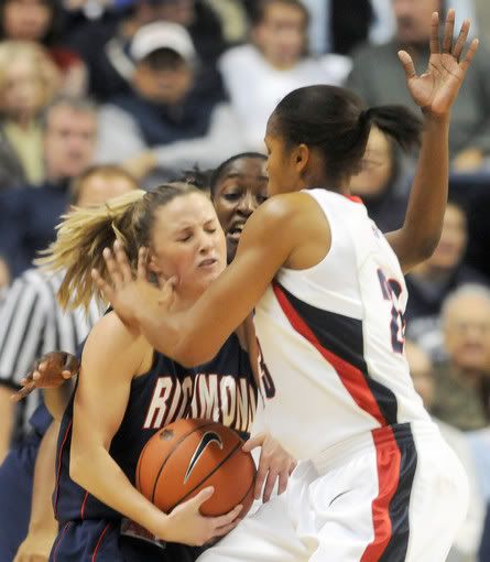 Richmond's Kara Powell is double-teamed by UConn's Maya Moore, right, and Kalana Greene during the first half Saturday at Gampel Pavilion - PATRICK RAYCRAFT / HARTFORD COURANT