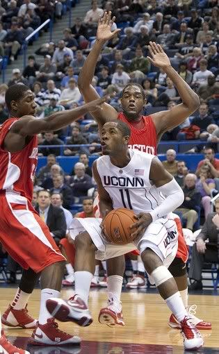 UConn's Jerome Dyson, right, battles through BU defenders during the first half. Dyson left the game briefly with what at first appeared to be a serious injury, but he later returned - AP Photo