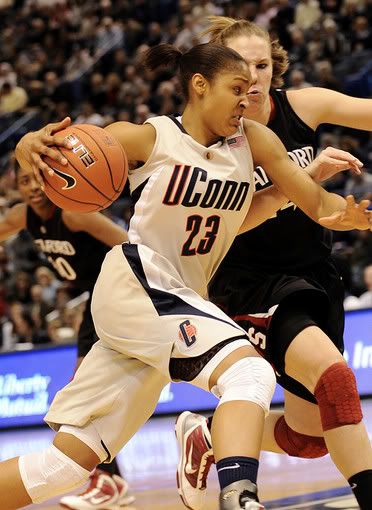 Maya Moore drives past Stanford's Kayla Pedersen en route to the hoop during the first half - AP Photo