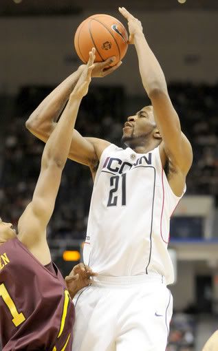 UConn's Stanley Robinson (No. 21) shoots during UConn's game against Iona - Tia Ann Chapman/Hartford Courant 